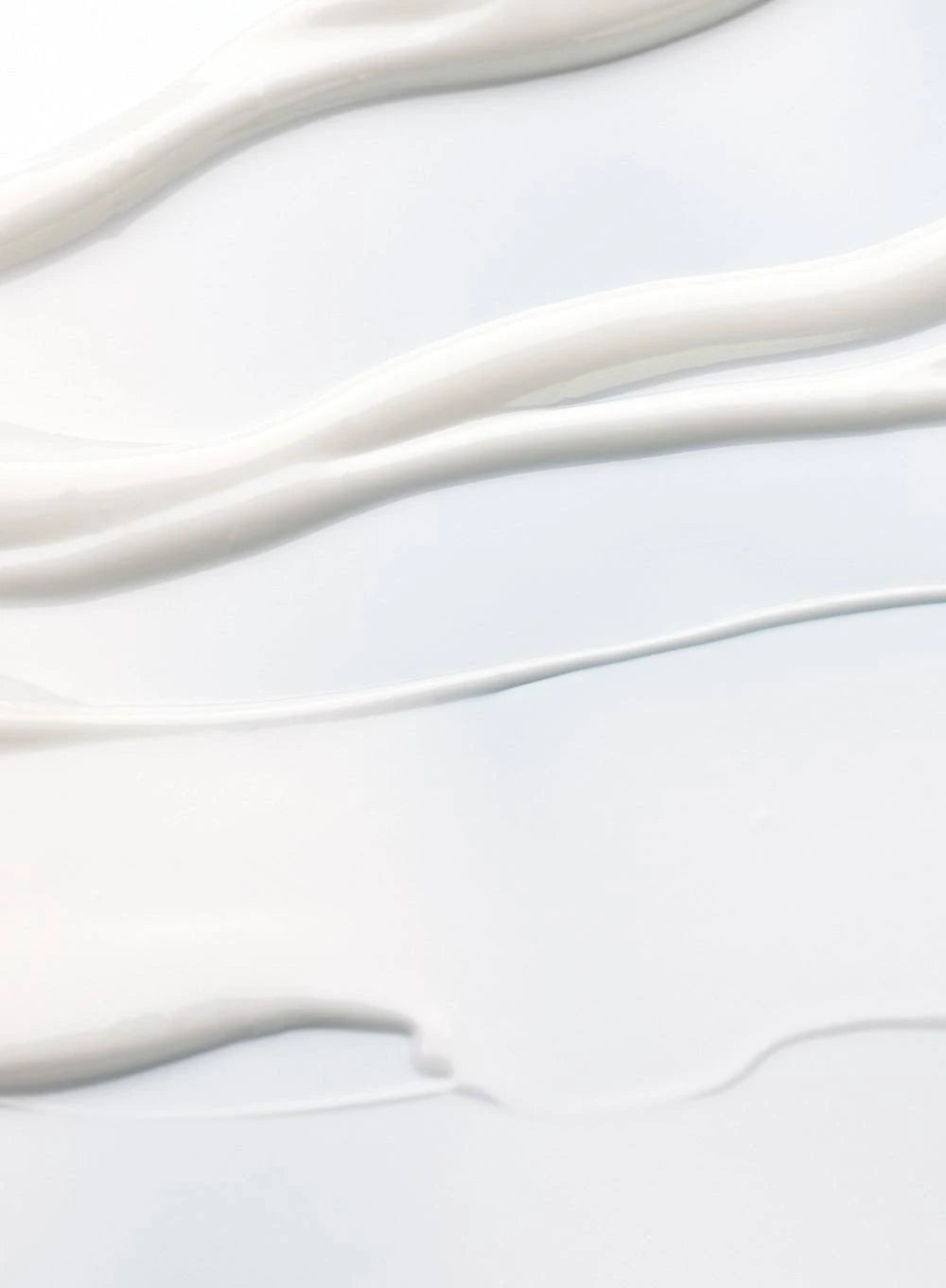 Close-up of smooth, creamy texture resembling sunscreen, highlighting its lightweight and moisturizing qualities.
