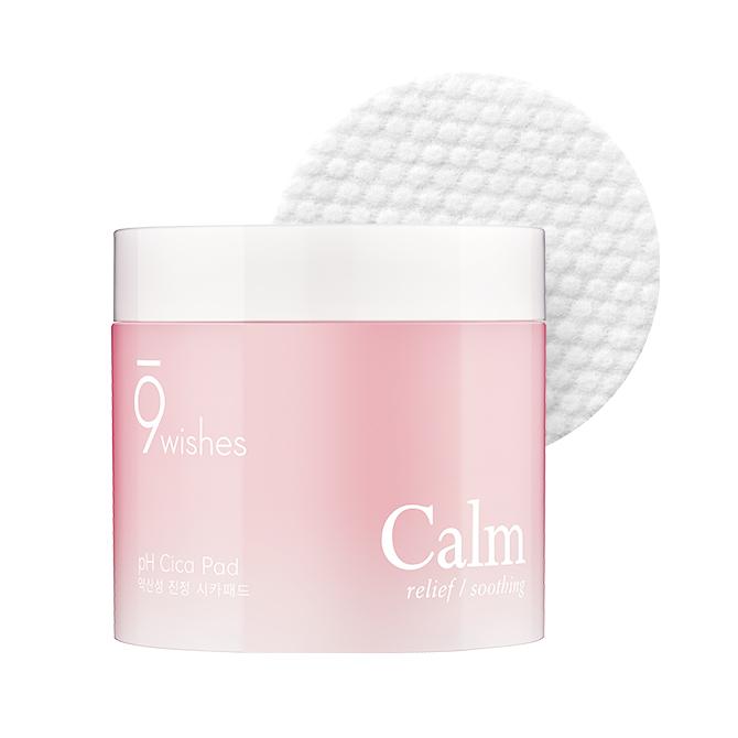 A container of 9wishes pH Calm Cica Toner Pad with one sheet partially placed on the container showing the product name and centella asiatica extract information.