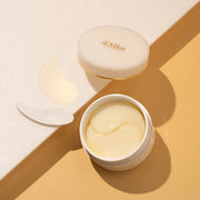 d'Alba White Truffle Eye Patch in gold-accented jar, shown with translucent hydrogel patches for under-eye care