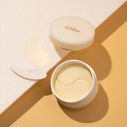 d'Alba White Truffle Eye Patch in gold-accented jar, shown with translucent hydrogel patches for under-eye care