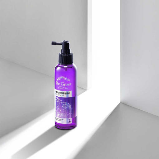 A bottle of Dr.Groot Microbiome Anti-Aging Tonic with a purple label and a black pump.