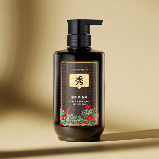 Dark bottle of Daeng Gi Meo Ri hair loss shampoo with herbal-themed design, gel texture for Korean scalp care