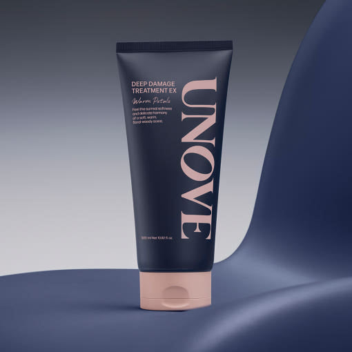 UNOVE Deep Damage Treatment EX 320ml tube in soft beige packaging, standing upright with sleek, minimal design on a neutral background