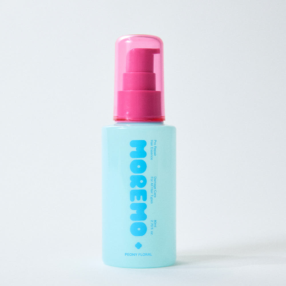 clear bottle of moremo Pro Repair Hair Essence with soft pink label, citrus floral Korean hair treatment, lightweight leave-in formula