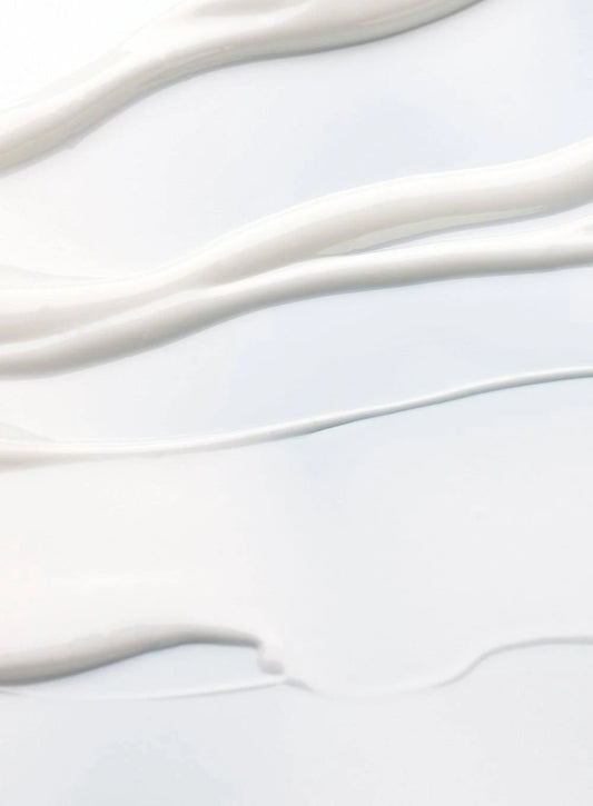 Close-up of smooth, creamy texture resembling sunscreen, highlighting its lightweight and moisturizing qualities.